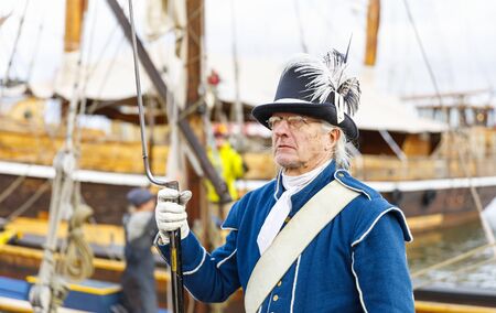 HELSINKI, FINLAND - OCTOBER 12, 2019: Sailor in ancient uniform stand on sailing ship at south...