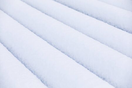 Closeup of lines of pure white snow piles at winterの写真素材