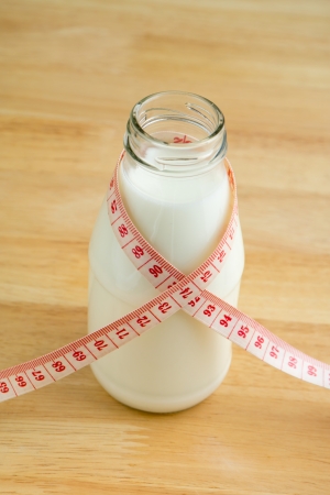 Milk bottle with tape measureの写真素材