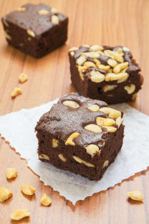 Brownies with nuts on wooden table