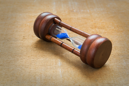 Hourglass on wooden tableの写真素材