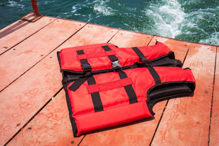 Red life jacket on boatの写真素材