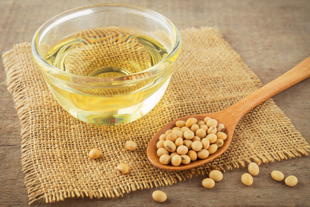 Soy beans and oil on sackの写真素材
