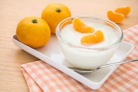 Fresh yogurt with orange fruit in bowlの写真素材