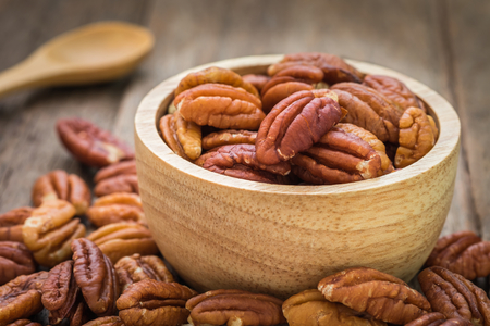 Pecan nuts in wooden bowlの写真素材