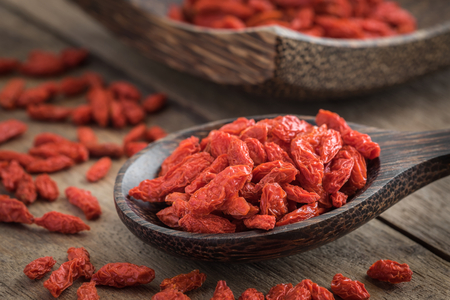 Goji berries on wooden spoonの写真素材