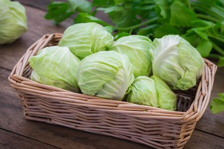 Cabbage in basket on wooden tableの写真素材