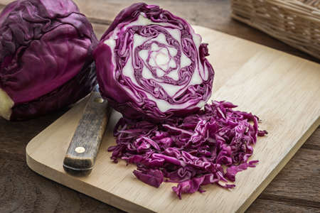 Red cabbage sliced on wooden cutting boardの写真素材