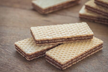 Wafers with chocolate on wooden tableの写真素材