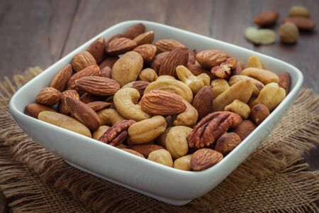 Mixed nuts in bowlの写真素材