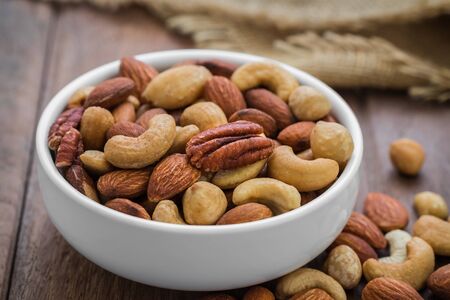 Mixed nuts in bowlの写真素材