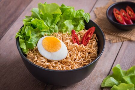 Instant noodles with egg in bowlの写真素材