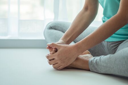 Woman practicing yoga, sitting in butterfly postureの写真素材