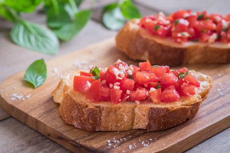 Bruschetta with chopped tomato and basil on toastの写真素材