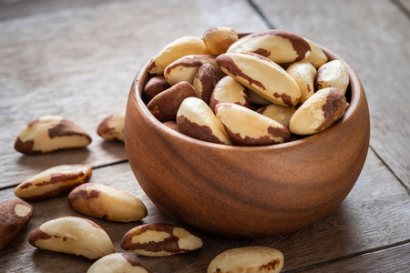 Brazil nuts in wooden bowlの写真素材
