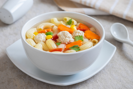 Macaroni chicken meatball soup in bowlの写真素材