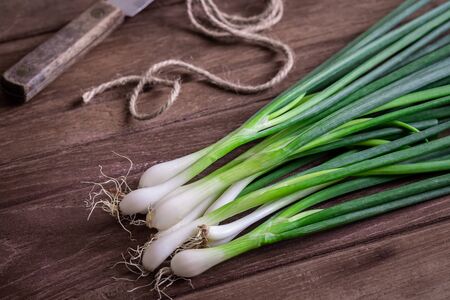 Fresh green onion on wooden tableの写真素材