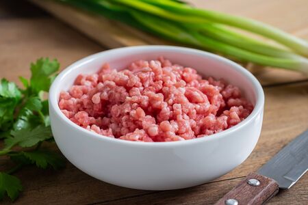 Raw minced pork in bowlの写真素材