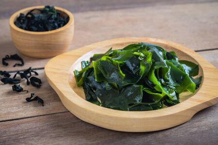 Wakame seaweed on wooden plateの写真素材