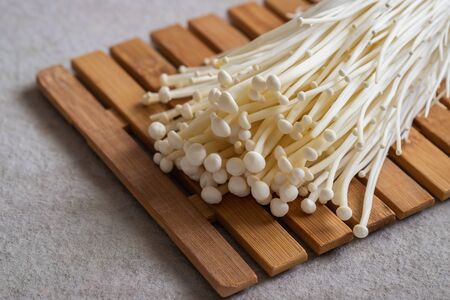 Enoki mushroom, Golden needle mushroom on wooden boardの写真素材