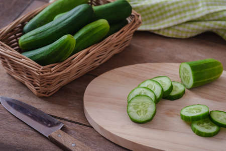Cucumber sliced on wooden cutting boardの写真素材