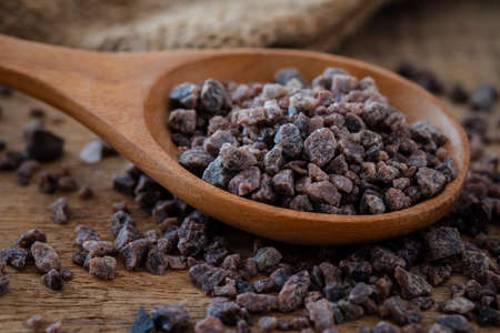 Himalayan black rock salt on wooden spoonの写真素材
