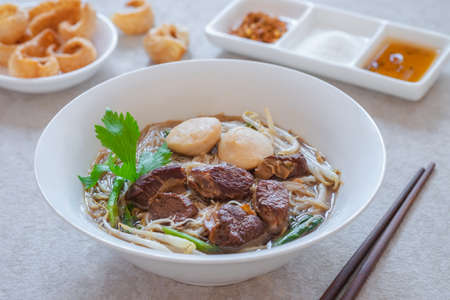 Noodle soup with braised pork and pork balls in bowl, Thai food styleの写真素材