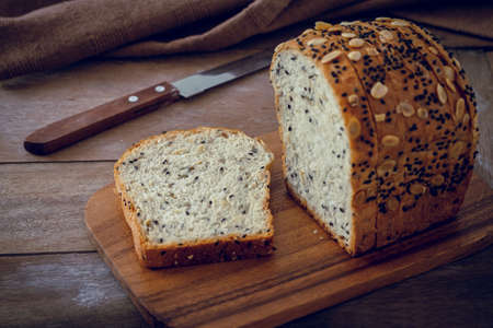 Whole grain bread slices on wooden boardの写真素材