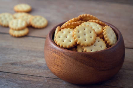 Crispy cracker biscuits in wooden bowlの写真素材