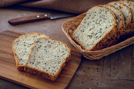 Whole grain bread slices on wooden boardの写真素材
