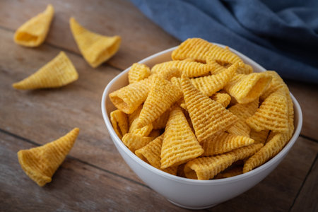 Crunchy corn snack in white bowlの写真素材