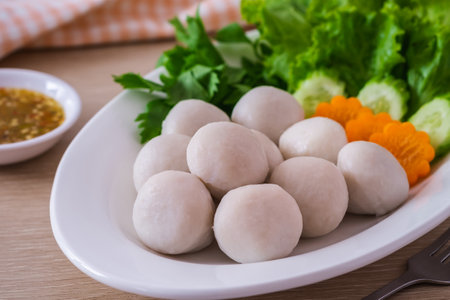 Boiled fish balls and vegetable on white plateの写真素材