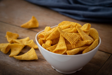 Crunchy corn snack in white bowlの写真素材
