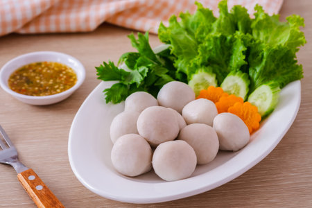 Boiled fish balls and vegetable on white plateの写真素材