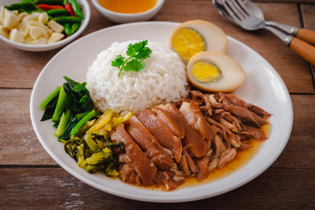 Stewed pork leg with boiled egg and rice on plateの写真素材