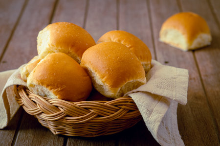 Soft bread rolls in wicker basketの写真素材