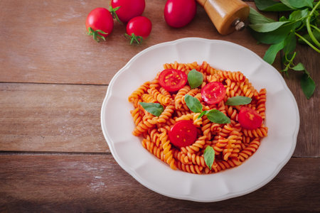 Fusilli pasta with tomato sauce and basilの写真素材