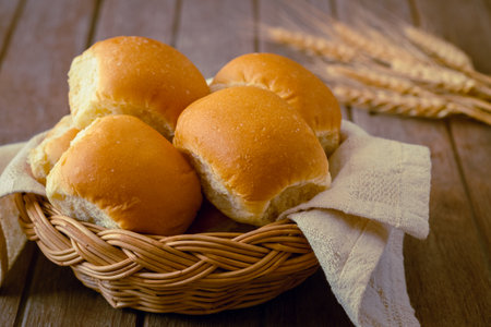 Soft bread rolls in wicker basketの写真素材