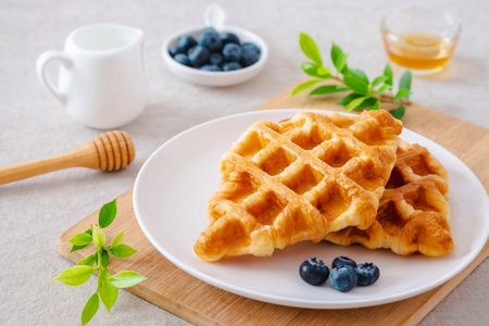 Croffle or croissant waffle with blueberries on plateの写真素材