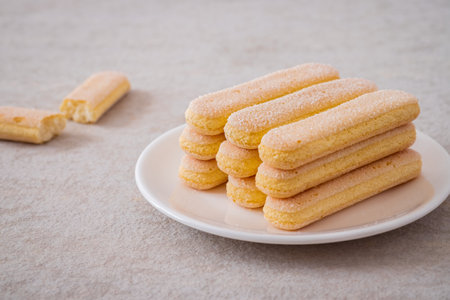 Lady finger biscuits, Italian dessert and sponge cookie on white plateの写真素材