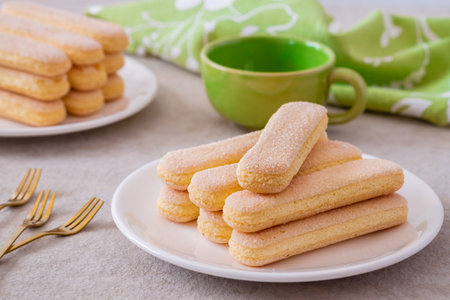Lady finger biscuits, Italian dessert and sponge cookie on white plate and coffee cupの写真素材