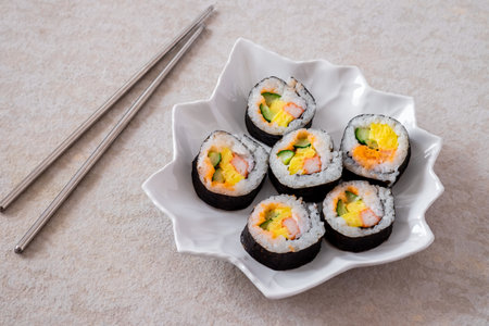 Maki sushi rolls on white plate and chopsticks-Japanese foodの写真素材