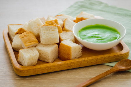 Slice steamed bread and pandan custard on wooden plateの写真素材