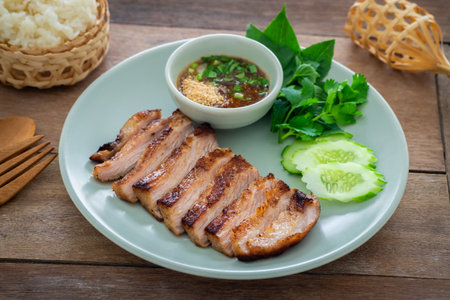 Grilled pork neck and thai spicy dipping sauce on plate served with sticky riceの写真素材