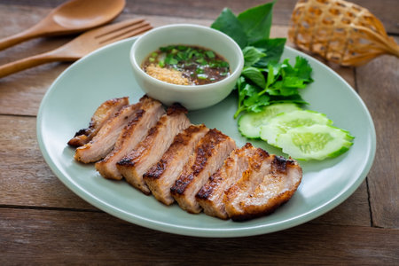 Grilled pork neck and thai spicy dipping sauce on plateの写真素材