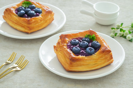 Blueberry danish puff pastry on white plateの写真素材