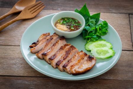 Grilled pork neck and thai spicy dipping sauce on plateの写真素材