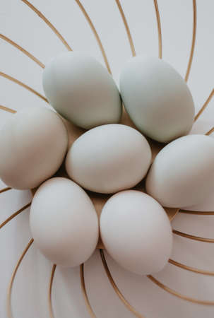 White eggs on a white background. Minimal concept.