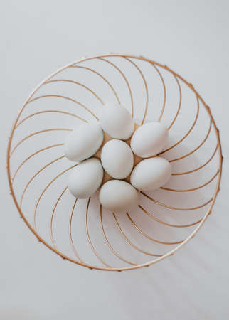 White eggs in a basket on a white background. View from above.の写真素材