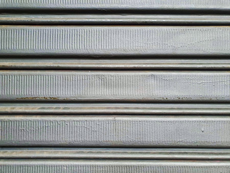 CUT OUT OF A METAL DOOR, WITH A TEXTURE COMPOSED OF LARGER LINES IN HORIZONTAL AND SMALL INTERNAL...